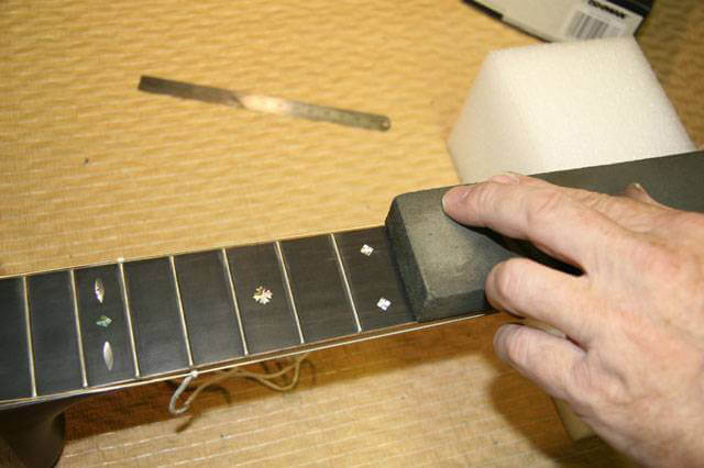 Fret level, fret rounding and polishing.